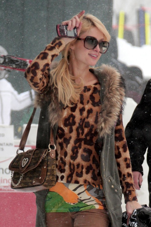 Paris Hilton poses for photographers as she heads home after a day on the snowy slopes of Aspen