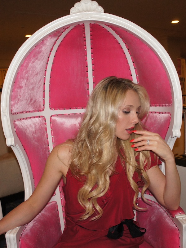 Gretchen sits in Gentleman Norman's pink chair!