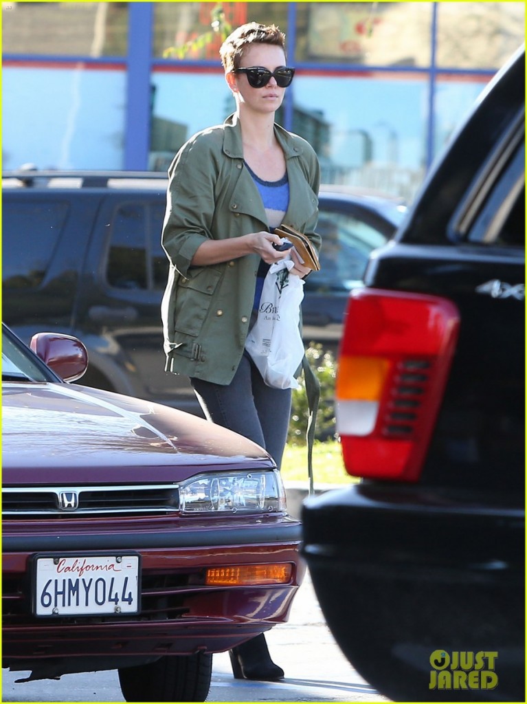 Charlize THeron wears military jacket to grocery