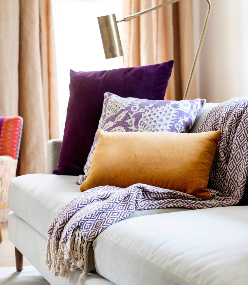 stacked pillows on a couch are great to layer a room