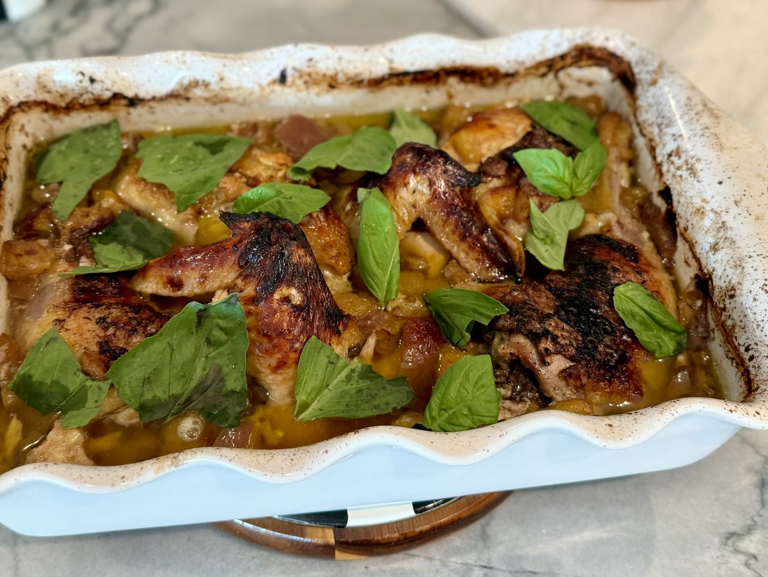 peach chicken in white casserole dish