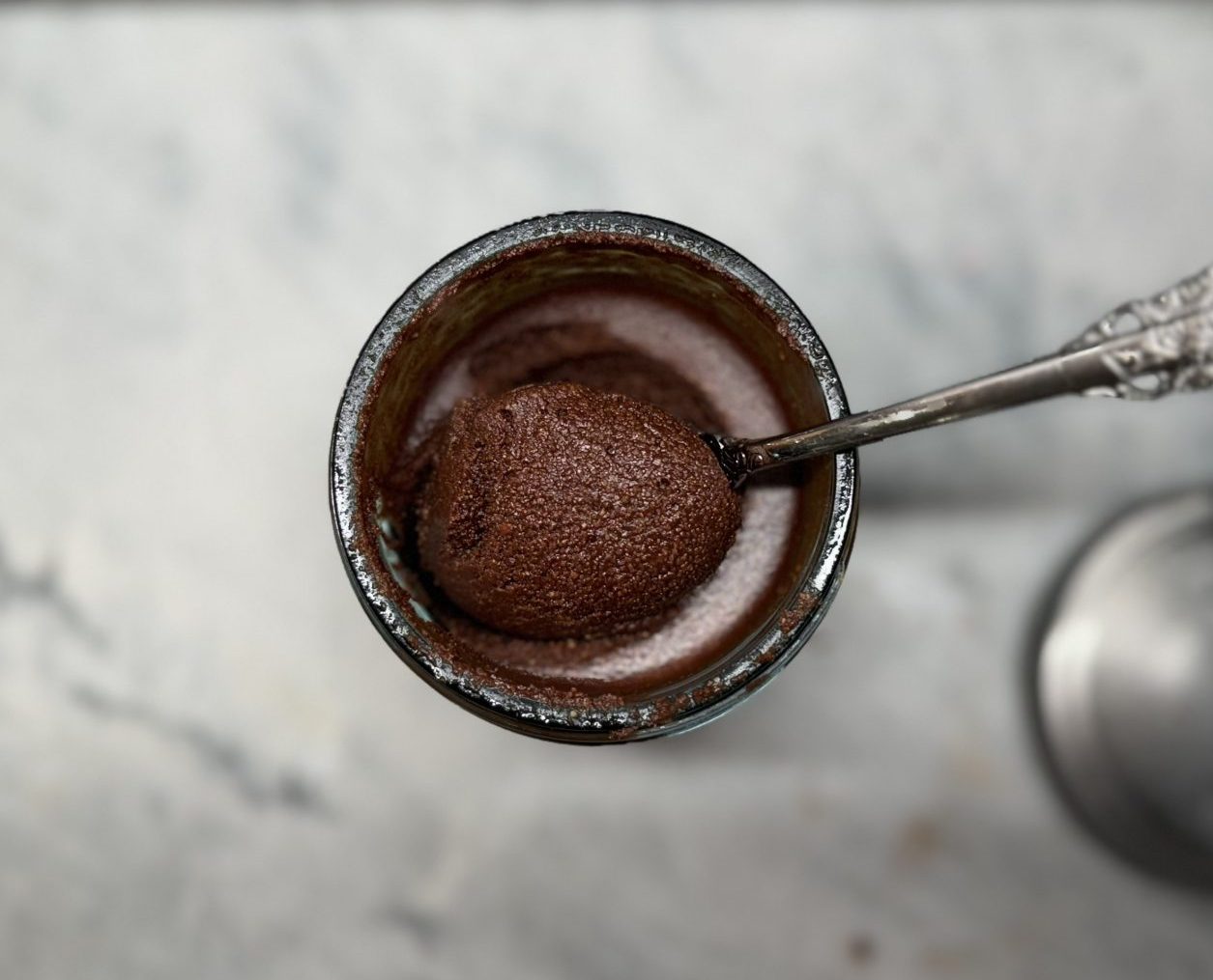 Homemade Nutella - closeup in jar with antique spoon