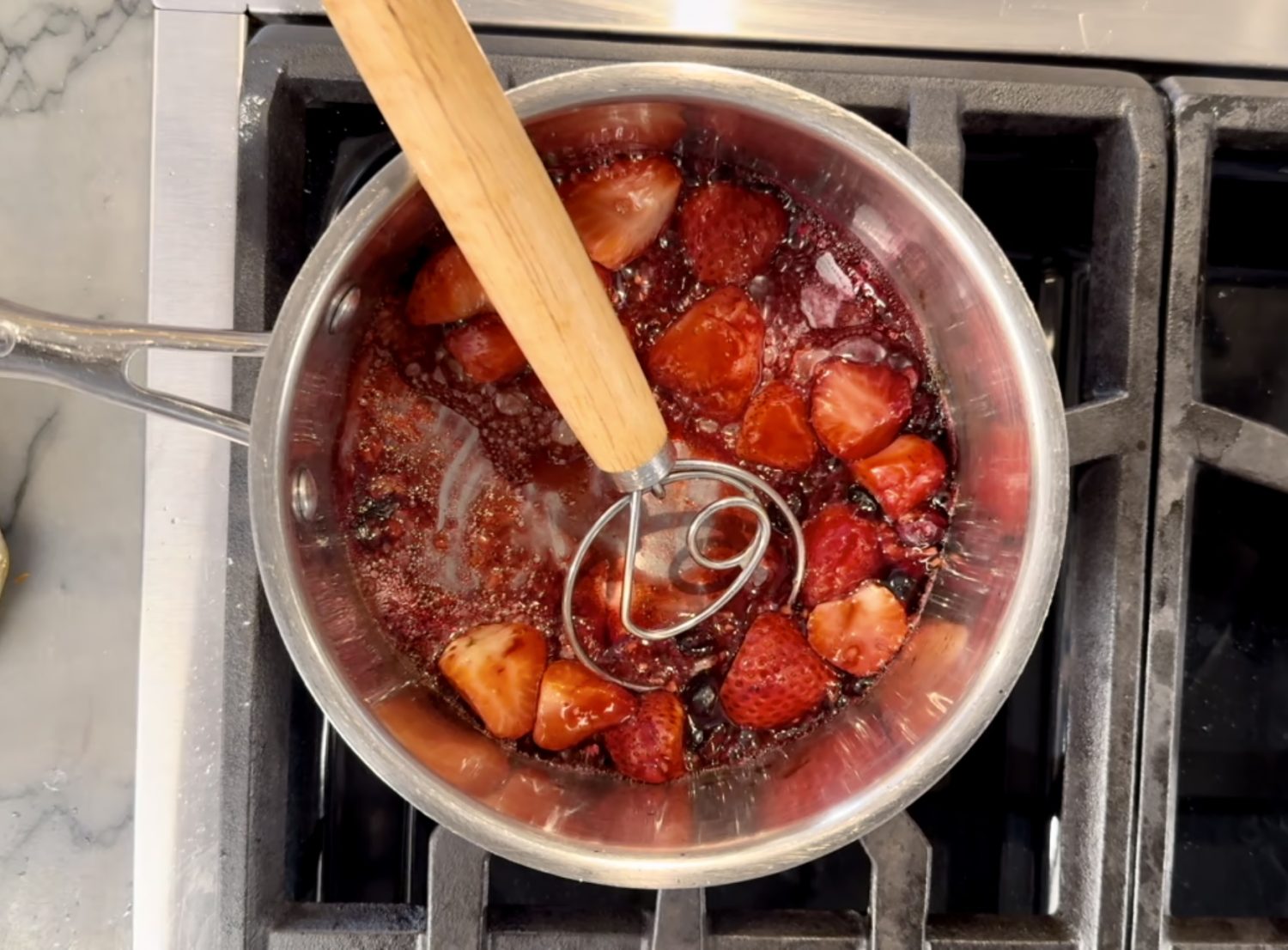 strawberries cooking on stove for homemade jam