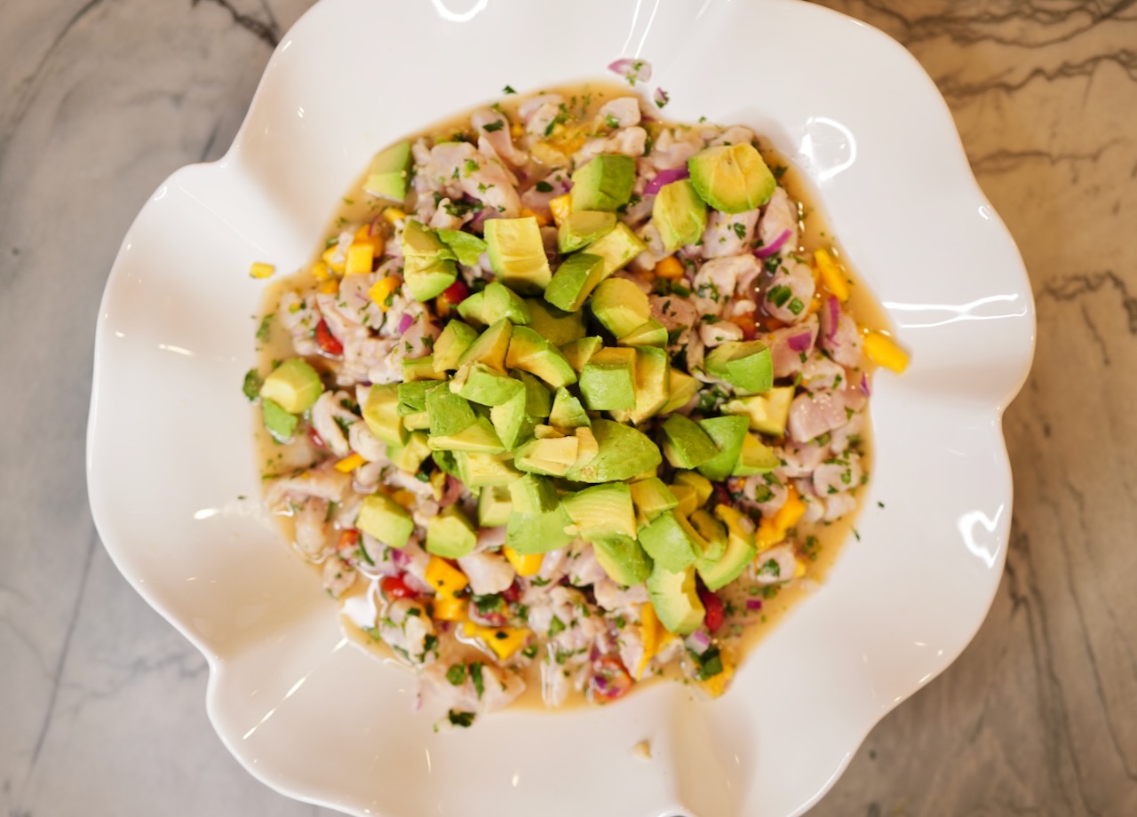 mango fish ceviche in white flower bowl