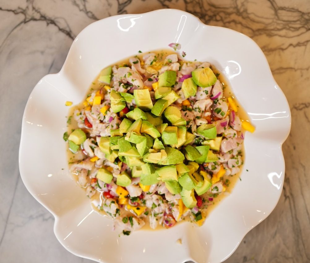 mango fish ceviche in large white party bowl