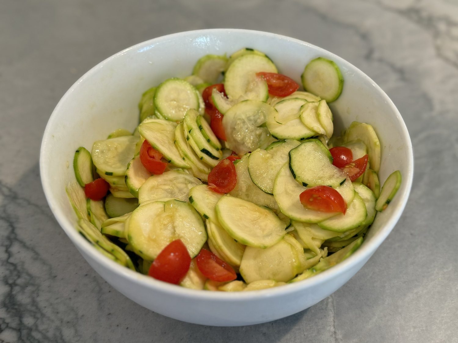 shaved zucchini salad in white bowl