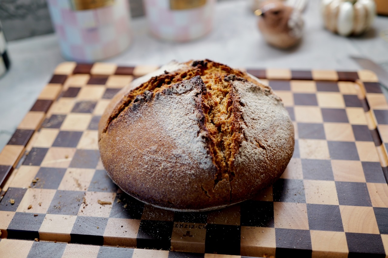 no-knead bread recipe - sourdough boule on checkered cutting board