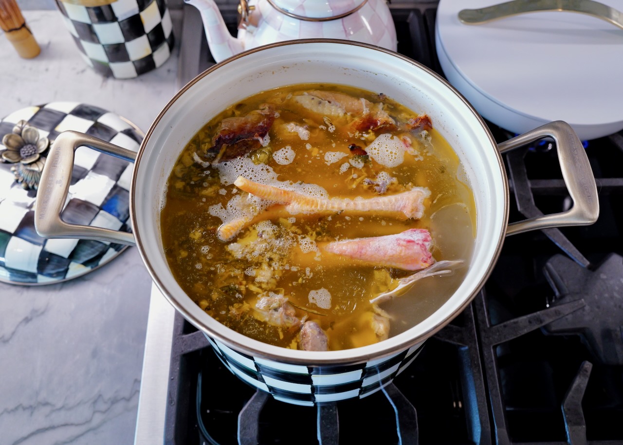 homemade chicken broth In a Mackenzie Childs stock pot