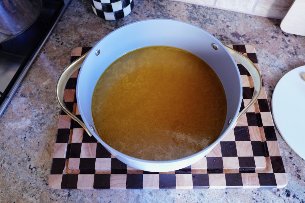homemade chicken broth in dutch oven