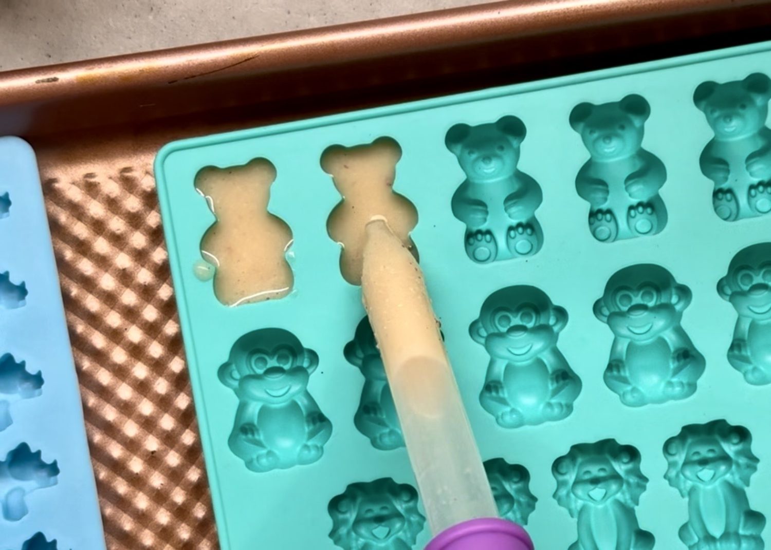 making homemade apple pie gummies with apple and gelatin in silicone molds